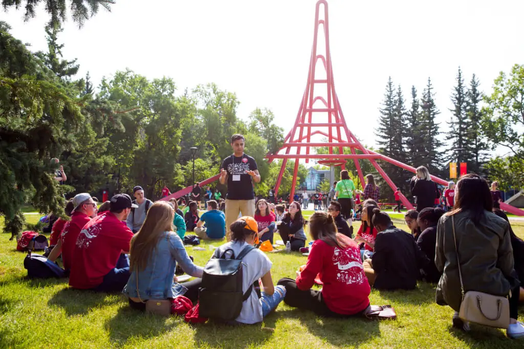A group of University of Calgary students sitting on the grass.